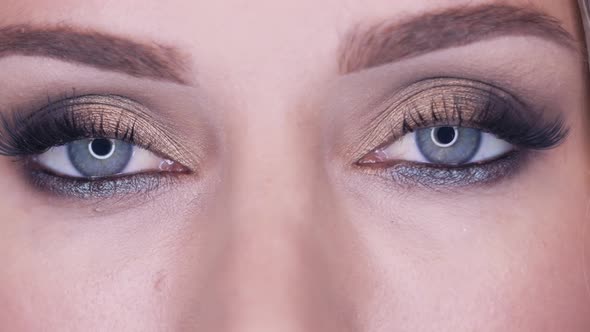 Sensual Girl Opens Her Eyes with Smokey Eyes Effect Makeup alt