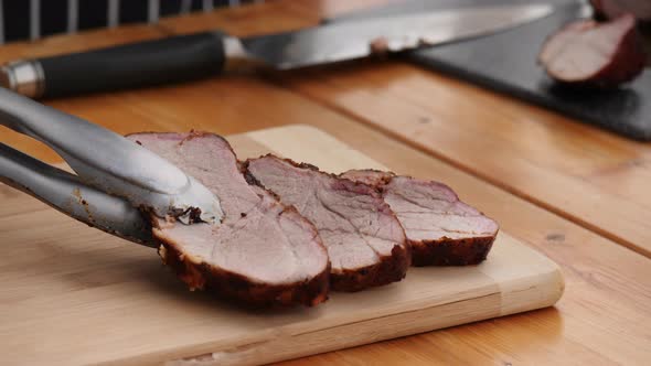 Chef Cook Cuts Roasted Slices of Well Grilled Meat