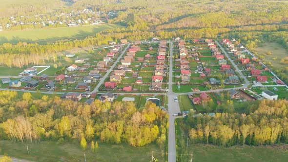 Small Cottage Village with Cute Houses Between Asphalt Roads alt