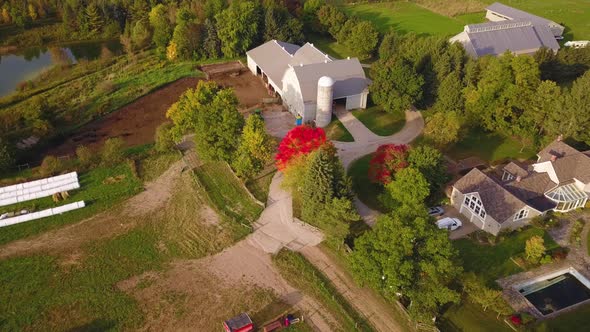 Scenic aerial circling over a picturesque farm in the countryside. alt