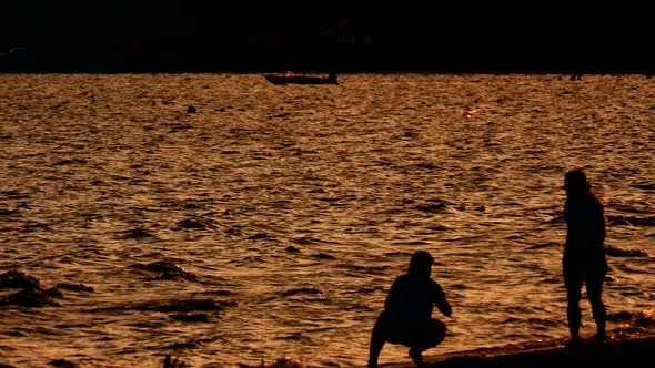 Evening walks along the sea coast. Romantic background.