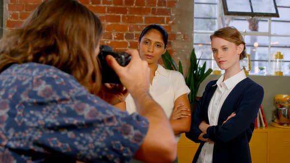 Executive taking picture of colleagues on vintage camera 4k alt