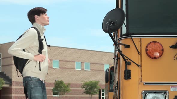 High school student waiting outside on school bus