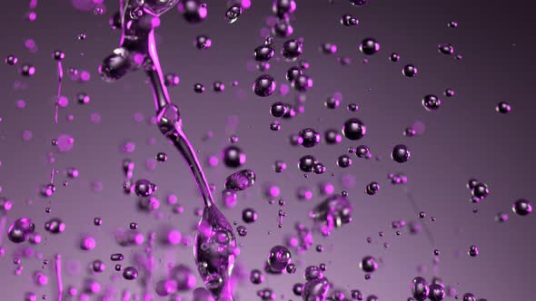 Super Slow Motion Shot of Splashing Oily Violet Liquid on Gradient Background at 1000Fps alt