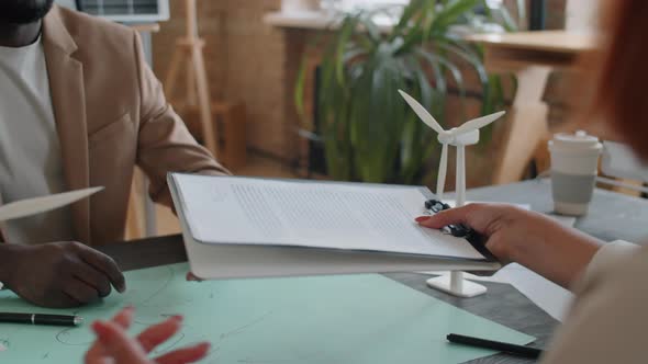 Multiethnic Partners Shaking Hand after Signing Renewable Energy Contract alt