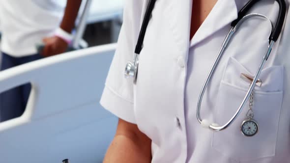 Female doctor writing a report alt