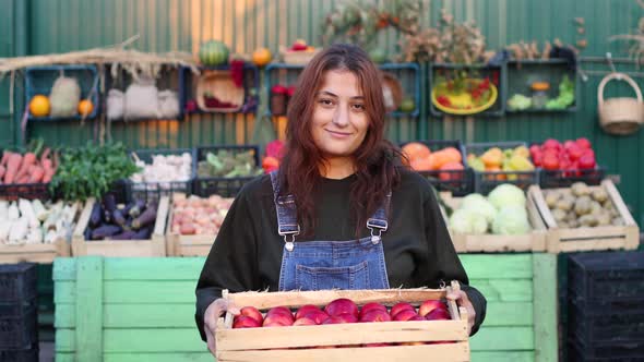 Woman Farmer (Seller) With Apples at the Farmer's Market. alt