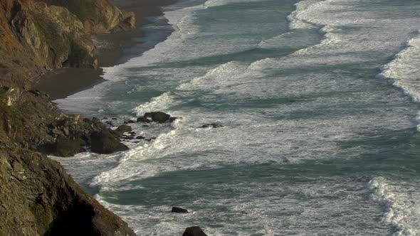 Waves Roll Toward Cliffs coastline / Landscape
