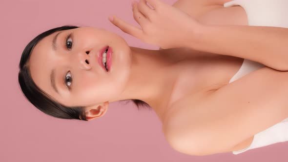 Beautiful Young Asian Woman Looking At Camera On Vertical Screen. alt