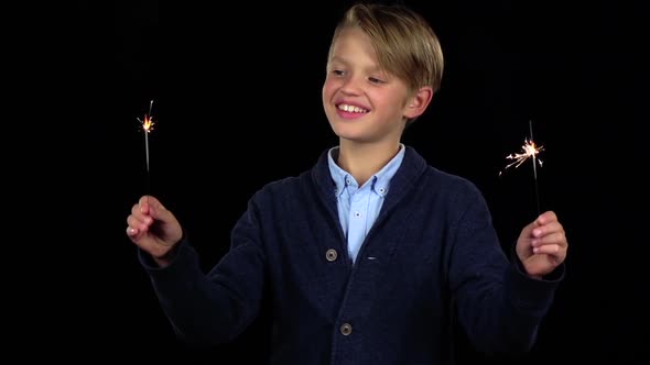 Guy Is Holding a Sparkler in His Hand. Black Background. Slow Motion alt