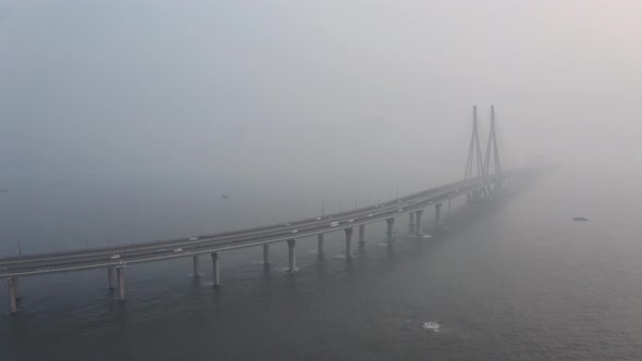 Drone shot towards large suspension bridge bandra worli sealink Mumbai on a hazy day alt