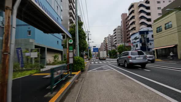 4k Time lapse of cars and trucks driving on a big road in the city of Tokyo, Japan. alt