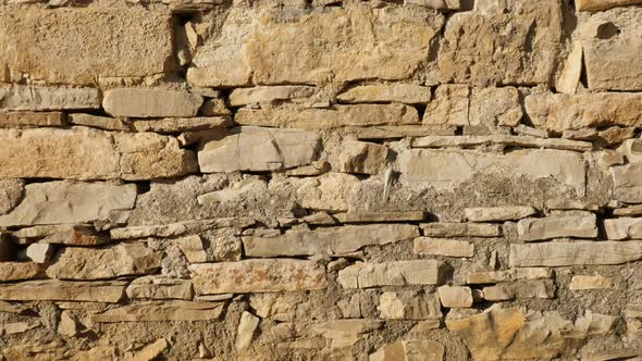 Layers of stone wall slow tilt 4K 2160p 30fps UltraHD footage - Ancient masonry construction close-u alt