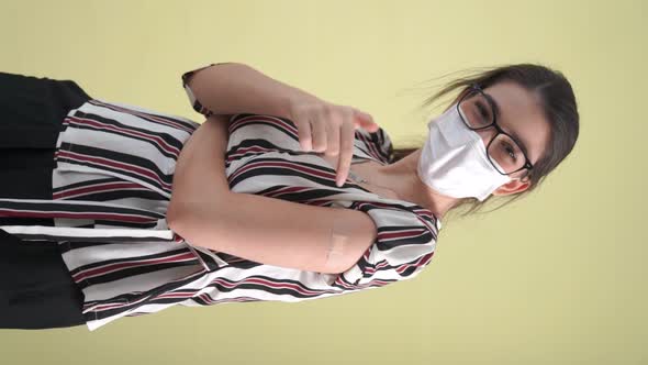 Vertical Video of Young Woman Showing COVID19 Vaccine Bandage Merrily alt
