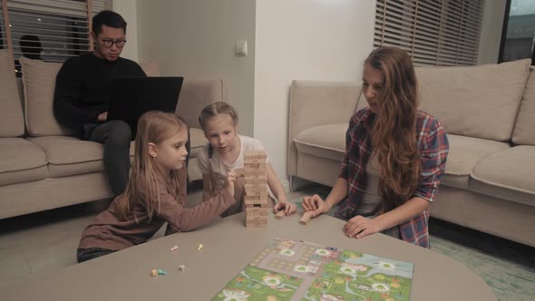 Parents playing board games with children