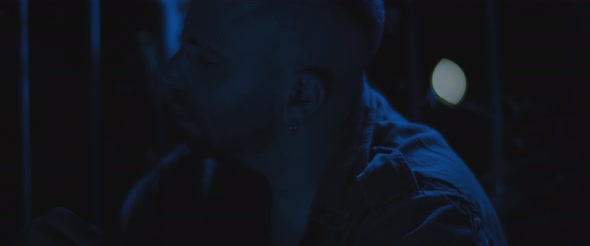 A soldier sitting alone outside at night, dealing with anxiety and post trauma. alt