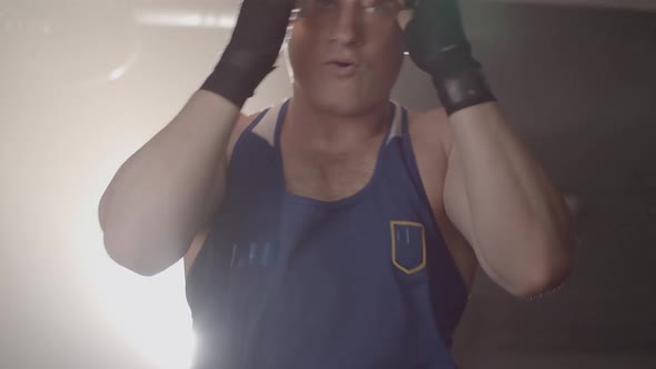 Live Camera Follows Young Sportsman Moving in Lense Flare in Haze. Portrait of Confident Caucasian alt