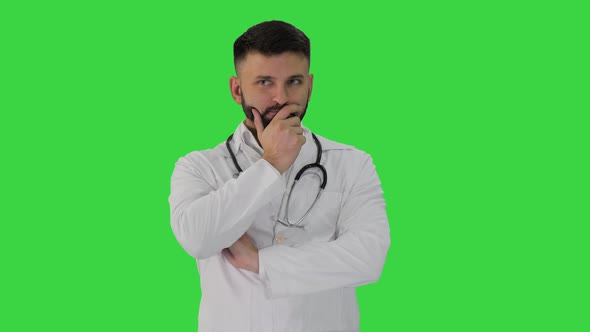 Doctor Standing and Thinking Hard on a Green Screen, Chroma Key. alt