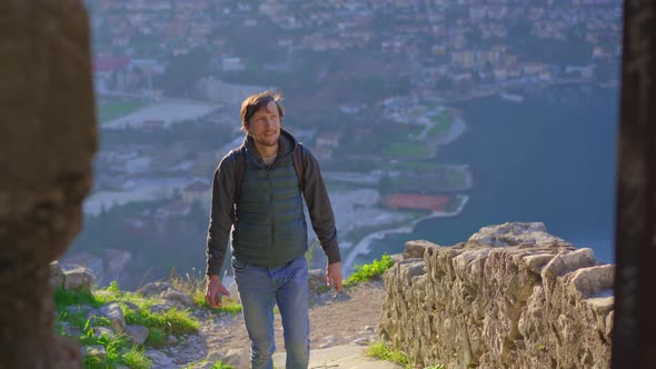 A Man Tourist Visits the Old Town of Kotor in Montenegro alt