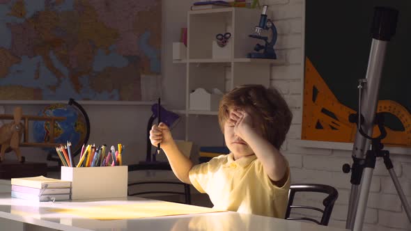 School Kids Against Green Chalkboard. Pupil Learning Letters and Numbers. alt