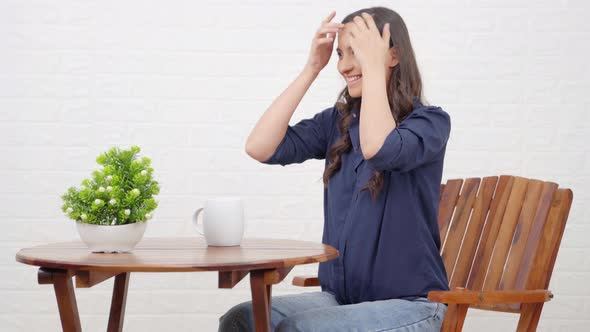 Indian girl getting ready for someone at a cafe alt