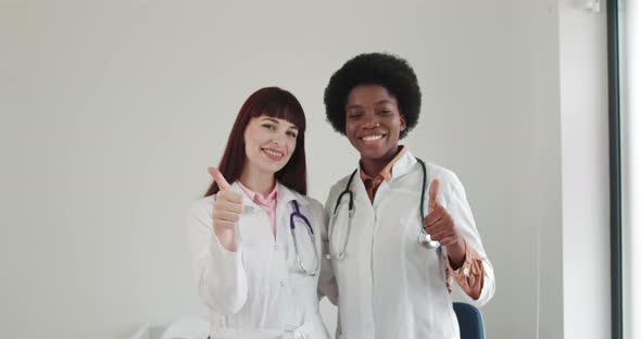 Two Smiling Women Doctors Cardiologist Wearing White Medical Coat And alt