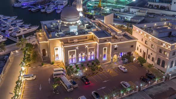 Yachts in Dubai Marina Flanked By the Al Rahim Mosque and Residential Towers and Skyscrapers Aerial alt
