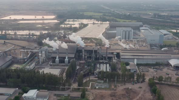 Aerial view Drone shot of flying around toxic chimneys tubing. Air Pollutants, Industrial zone.