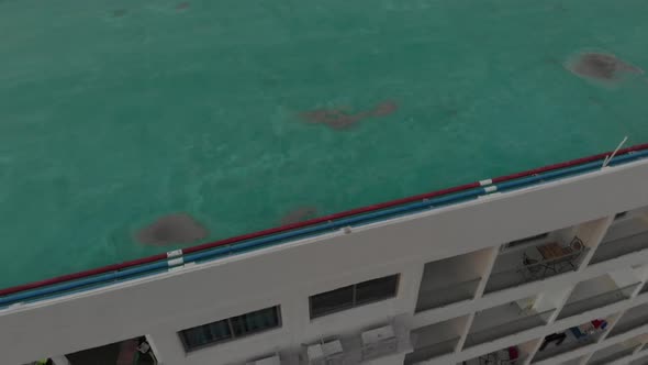 Camera Zooms Out Big Building with Windows and Balconies alt