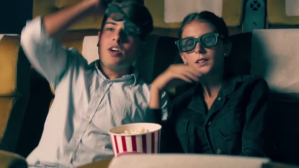 Man and Woman in the Cinema Watching a 3D Movie alt