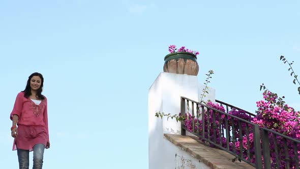 Young woman walking down steps alt