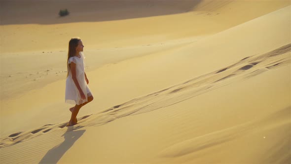 Girl Among Dunes in Rub al-Khali Desert in United Arab Emirates alt