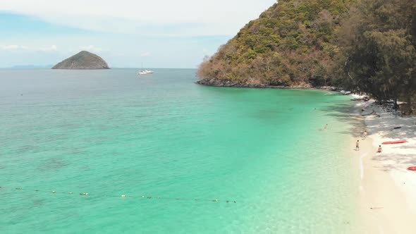Emerald shallow shoreline and lush green coast of Banana Beach in Coral Island (Koh Hey), Thailand alt