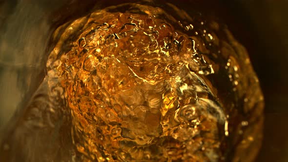 Super Slow Motion Abstract Shot of Pouring Golden Liquid in Glass Bottle at 1000 Fps alt