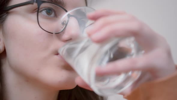 Brunette Girl Drinking Water From a Glass Closeup Cinematic Shot