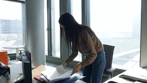 A Young Woman Sneaks Into the Office and Searches Documents