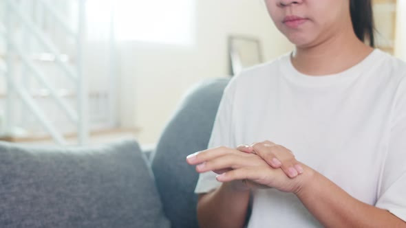 Asian woman using alcohol spray hand sanitizer wash hand for protect coronavirus. alt