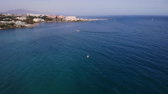 Aerial Over The Alboran Sea In The Costa Del Sol With Pedestal Down To Floating Boat alt