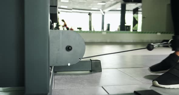 Strong Pretty Woman Training Muscle on Sport Simulator in Sport Club. Athlete Female Doing Exercise alt