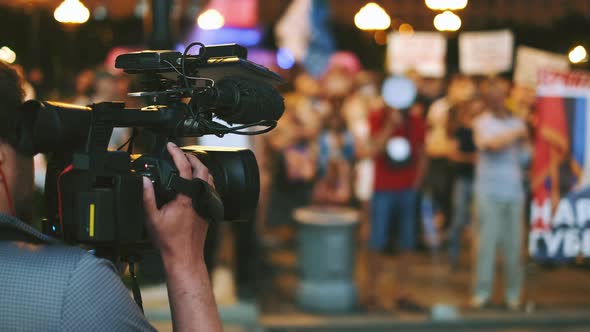 Camera Man Shoots Rally Activists with Posters Banners on Political Protest alt