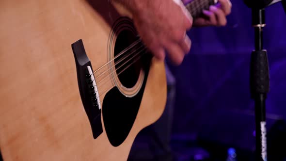 A Musician is Dynamically Playing the Guitar at the Rock Concert Closeup