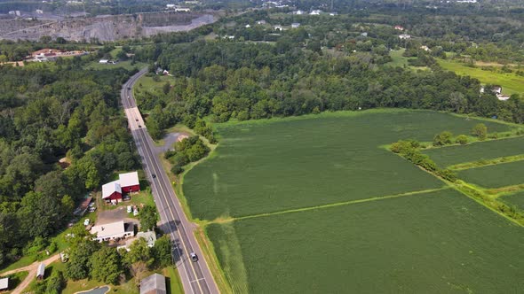 Aerial View of American Countryside Landscape Farmland Farm, Field Near Opencast Mining Quarry in alt