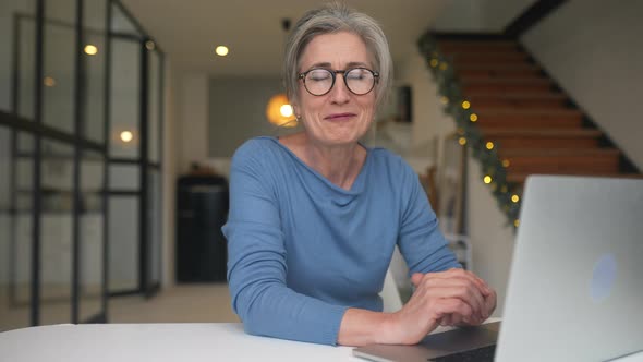 Happy Mature Middle Aged Elderly Woman Talking to the Camera alt