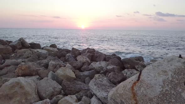 Beautiful pink and yellow hues of sunrise over the Jaffa harbor alt