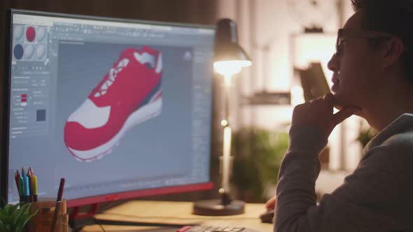 Close Up Of Asian Male Footwear Designer Thinking Then Raising Index Finger While Designing Shoe alt