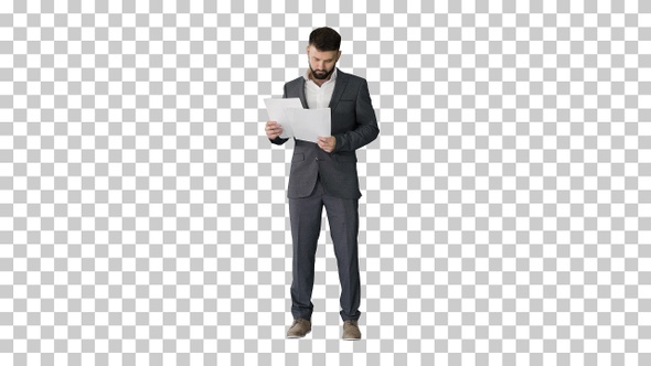 Businessman standing and reading papers seriously, Alpha Channel alt