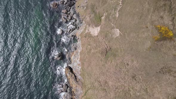 Waves Splashing On Rocky Coast In Howth, Dublin, Ireland With Scenic Top View Of Rugged Cliffs In Su alt