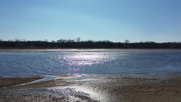 ‎⁨A low angle view of Rancocas Creek in NJ on a sunny day. The drone dolly in towards the creek from alt