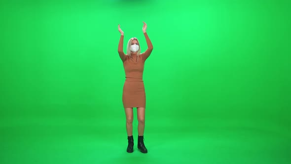 Female Dancing at a Concert Woman in Protective Medical Mask at a Music Concert Dance and Claps alt