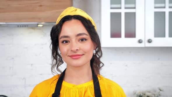 Close Up Smiling Beautiful Housewife Looking at Camera in Home Modern Kitchen alt